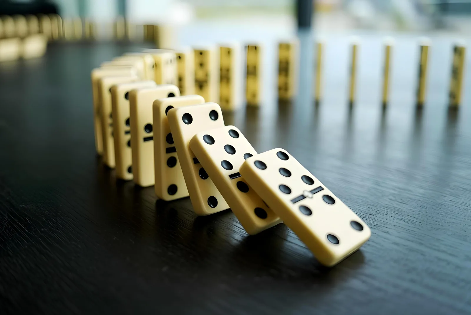 A line of dominos falling