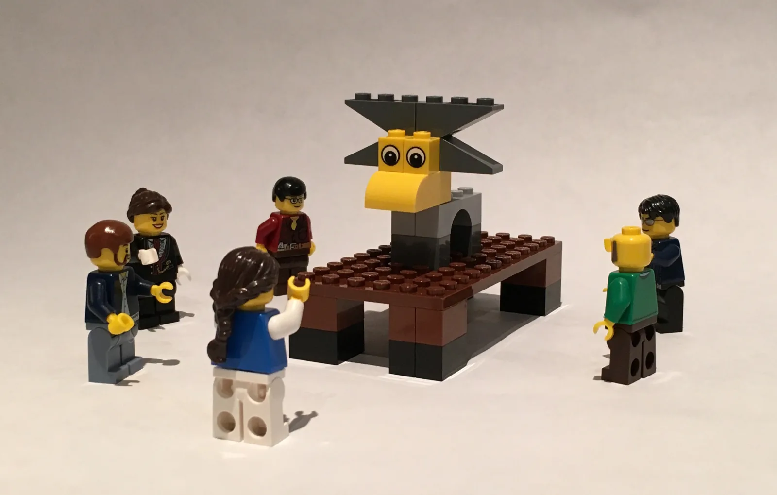 A LEGO model of a moose with people standing around it.